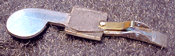 Underside of a key, showing riveted spring